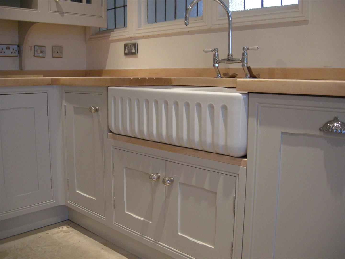 Redbrook kitchens design and install bespoke kitchens in Gloucestershire Traditional Shaker with panel moulded frame, showing sculptured Belfast type sink