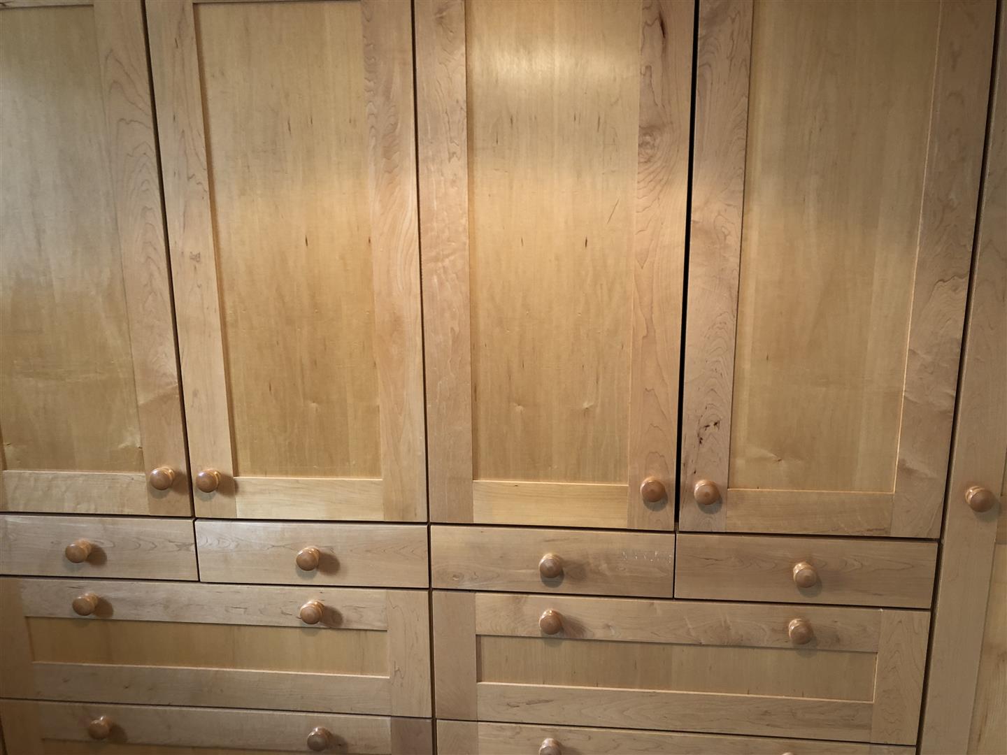 A close up of the built-in maple wardrobe and drawers.