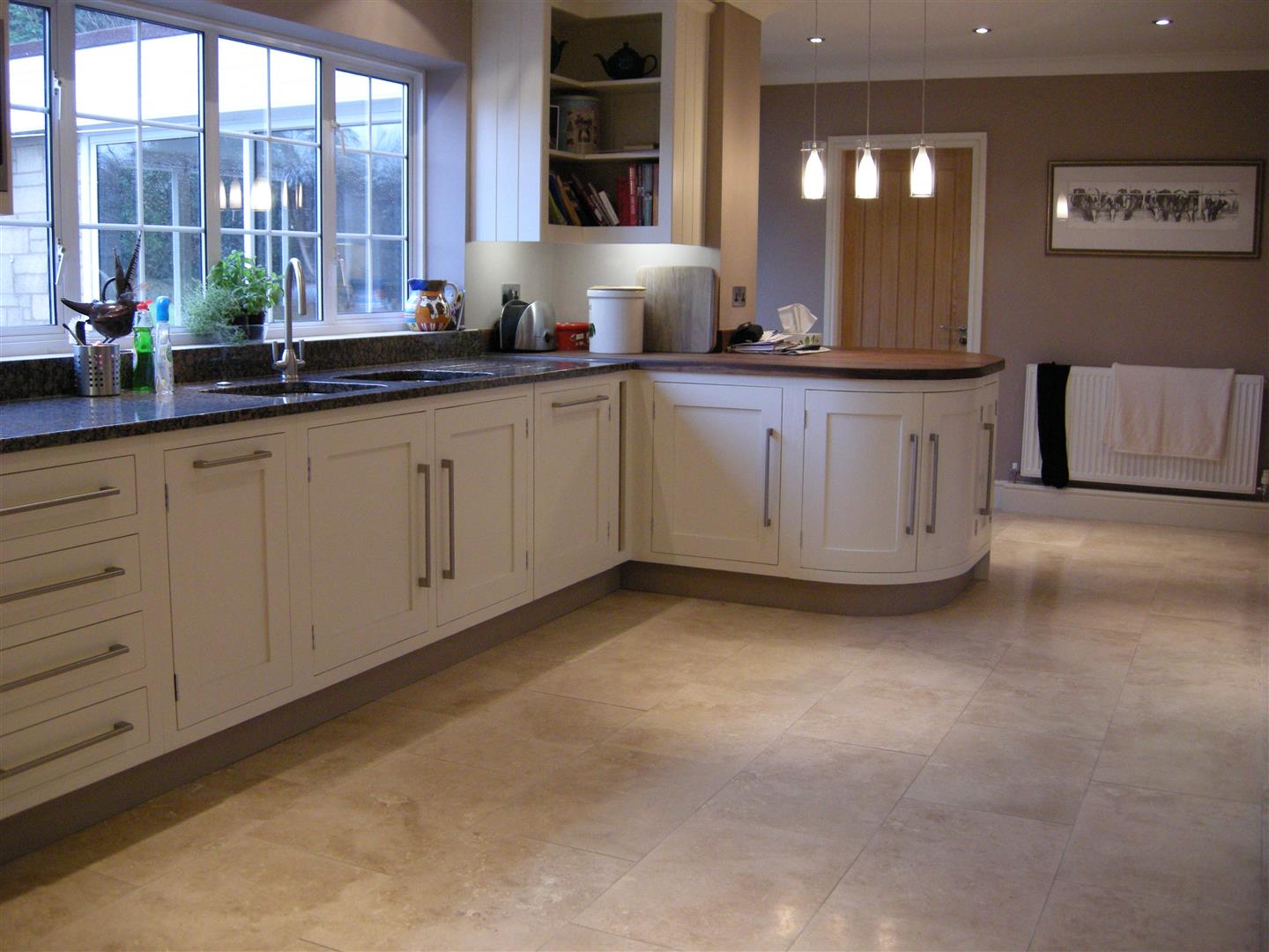 Redbrook kitchens design and install bespoke kitchens in Gloucestershire. Large Shaker kitchen with contemporary handles