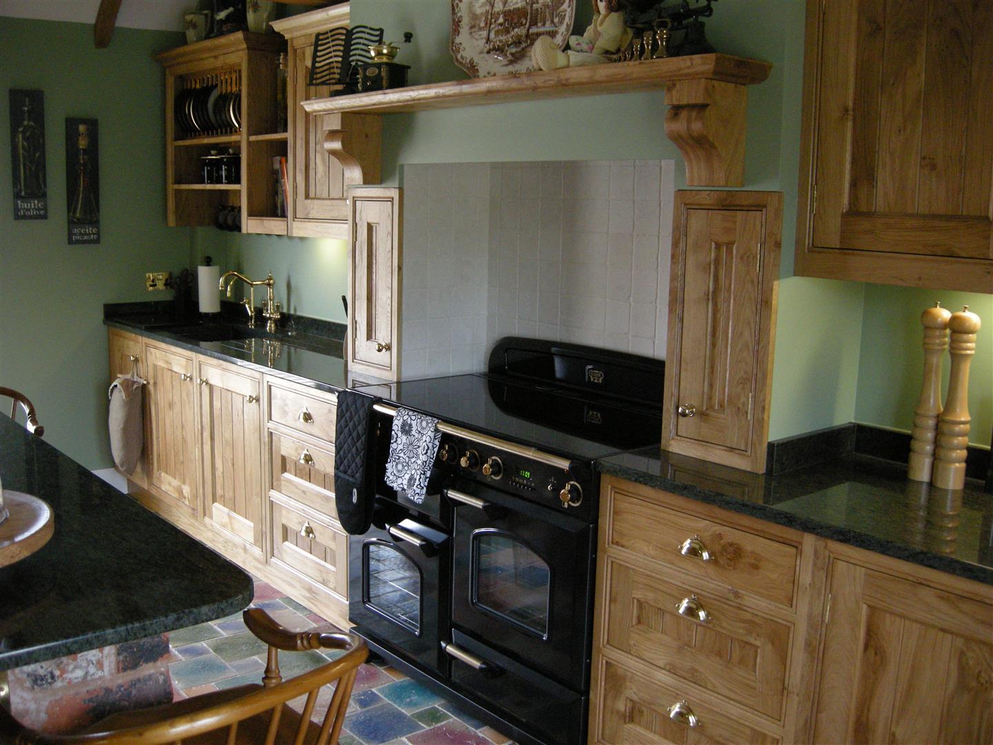 Redbrook kitchens design and install bespoke kitchens in Gloucestershire. Poppy oak front framed kitchen with toungue and groove centre panels in traditional style
